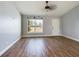 Spacious living room with wood-look floors and a ceiling fan at 8 Dogwood Circle Pl, Ocala, FL 34472