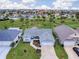 Beautiful aerial view of the single-story home in a lush community with palm trees and green spaces at 802 Nancy Dr, The Villages, FL 32163