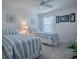 Bright bedroom with two twin beds featuring striped bedding, offering a cozy and inviting space at 802 Nancy Dr, The Villages, FL 32163