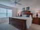 King-size bed in a bright bedroom with ample natural light and window coverings at 802 Nancy Dr, The Villages, FL 32163