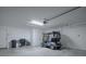 Spacious garage featuring a golf cart, ample storage, and a clean, well-lit area at 802 Nancy Dr, The Villages, FL 32163