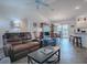 Inviting living room with an open layout leading into the dining area, perfect for entertaining and relaxing at 802 Nancy Dr, The Villages, FL 32163