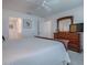 Tranquil bedroom featuring a dresser and vanity with a white comforter and ceiling fan at 802 Nancy Dr, The Villages, FL 32163