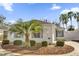 White exterior house with palm trees and a landscaped yard at 814 Hilda Way, The Villages, FL 32162