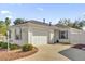 White house exterior with a large garage and driveway at 814 Hilda Way, The Villages, FL 32162