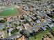 Aerial view of Spruce Creek Country Club, featuring residential homes and a pond at 8460 Se 137Th Loop, Summerfield, FL 34491