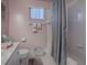 Clean bathroom with grey shower curtain and white tile at 8460 Se 137Th Loop, Summerfield, FL 34491