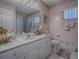 Bathroom with pink walls, marble vanity, and shower at 8460 Se 137Th Loop, Summerfield, FL 34491