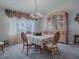 Dining room with a chandelier, wood hutch, and wicker chairs at 8460 Se 137Th Loop, Summerfield, FL 34491