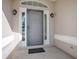 Gray front door with a decorative metal screen and sidelights at 8460 Se 137Th Loop, Summerfield, FL 34491