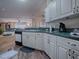 Kitchen with white cabinets, green countertops, and modern appliances at 8460 Se 137Th Loop, Summerfield, FL 34491