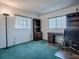 Home office with wood desk, shelving, and green carpet at 8460 Se 137Th Loop, Summerfield, FL 34491