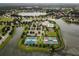 Aerial view of community with lake, tennis courts, and pool at 8493 Hartford Way, Mount Dora, FL 32757