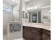 Bathroom with shower, vanity, and window at 8493 Hartford Way, Mount Dora, FL 32757