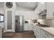 Modern kitchen with stainless steel appliances and white cabinets at 8493 Hartford Way, Mount Dora, FL 32757