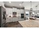 Modern kitchen with stainless steel appliances and white cabinets at 8493 Hartford Way, Mount Dora, FL 32757