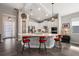 Modern kitchen with white cabinets, large island, and red barstools at 8493 Hartford Way, Mount Dora, FL 32757