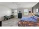 Spacious main bedroom with a king bed and calming decor at 8493 Hartford Way, Mount Dora, FL 32757