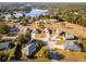 Serene aerial perspective of a home near a lake, set in a neighborhood with mature trees at 85 Golfview Cir, Umatilla, FL 32784