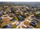 An aerial view of the home nestled in a well-maintained neighborhood with mature trees at 85 Golfview Cir, Umatilla, FL 32784