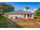 Exterior back of house featuring outdoor seating and lush landscaping, ideal for relaxing or entertaining at 85 Golfview Cir, Umatilla, FL 32784