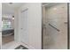 Bathroom entryway with a glass shower and views of the bedroom at 85 Golfview Cir, Umatilla, FL 32784