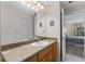 Bathroom featuring a single sink, a large mirror, and an entry to the bedroom at 85 Golfview Cir, Umatilla, FL 32784