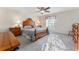 Cozy bedroom featuring wood furniture, a ceiling fan, and lots of natural light at 85 Golfview Cir, Umatilla, FL 32784