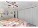 Bedroom featuring double closets, ceiling fan, carpeted floors, and bright natural light at 85 Golfview Cir, Umatilla, FL 32784