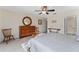 Neutral bedroom featuring wood furniture, a mirror, and a bright window at 85 Golfview Cir, Umatilla, FL 32784