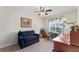 Bedroom featuring a sofa and desk space, with a ceiling fan at 85 Golfview Cir, Umatilla, FL 32784