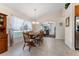 Bright dining room with large windows, natural light, and a wooden table set perfect for entertaining at 85 Golfview Cir, Umatilla, FL 32784