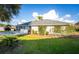 View of the back of the house with a spacious yard and landscaping, providing a private outdoor space at 85 Golfview Cir, Umatilla, FL 32784