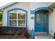 Close-up of front door featuring glass accents and the house number, complemented by tidy landscaping at 85 Golfview Cir, Umatilla, FL 32784