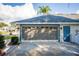 Spacious screened garage with an attached blue door, offering ample parking and storage at 85 Golfview Cir, Umatilla, FL 32784