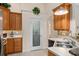 Kitchen features oak cabinets, a tiled backsplash, and a walk-in pantry door at 85 Golfview Cir, Umatilla, FL 32784