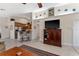 Bright living room with tile floors, a ceiling fan, and an archway leading to the kitchen with bar stool seating at 85 Golfview Cir, Umatilla, FL 32784