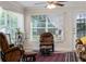 Cozy living room with large windows, a ceiling fan, and plush seating at 85 Golfview Cir, Umatilla, FL 32784