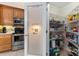 View of a large walk-in pantry with frosted door and wire shelving in the kitchen at 85 Golfview Cir, Umatilla, FL 32784