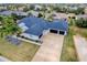 Aerial view of house, two-car garage, and landscape at 858 Pinckney Ln, The Villages, FL 32162