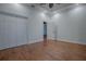 Well-lit bedroom with hardwood floors and double door closet at 858 Pinckney Ln, The Villages, FL 32162