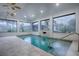 Indoor pool with a calming water feature and plenty of natural light at 858 Pinckney Ln, The Villages, FL 32162