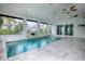 Enjoy this indoor pool with large windows and a stone water feature at 858 Pinckney Ln, The Villages, FL 32162