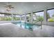 Indoor pool with a tranquil water feature and bright, airy space at 858 Pinckney Ln, The Villages, FL 32162