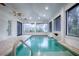 Relax in this indoor pool area featuring large windows and a water feature at 858 Pinckney Ln, The Villages, FL 32162