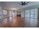 Spacious living room with hardwood floors and pool view at 858 Pinckney Ln, The Villages, FL 32162