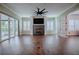 Living room with a fireplace, hardwood floors and sliding doors leading to the patio at 858 Pinckney Ln, The Villages, FL 32162