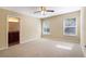 Large bedroom with neutral carpeting and two windows at 870 Vindale Rd, Tavares, FL 32778