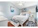 Cozy bedroom featuring a comfortable bed, a ceiling fan, and stylish decor at 893 Fenwick Loop, The Villages, FL 32163