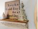 Charming shelf with decor, featuring a sign that reads, 
